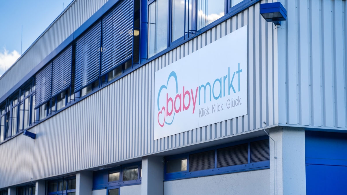 Photo of a warehouse with the babymarkt logo on a sign on the wall